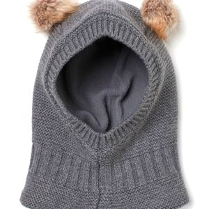 Knit balaclava in soft cotton with faux fur pompoms at top. Fleece lining,